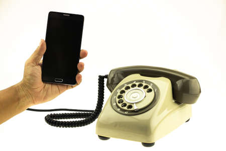 vintage picture style of New smart phone with old telephone on white background. New communication technology.の写真素材