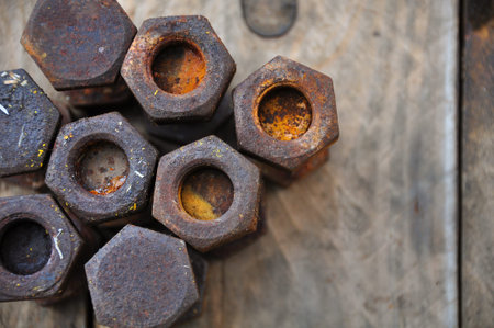 Old bolts or dirty bolts on wooden background, Machine equipment in industry work.
