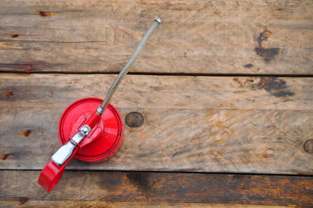 Oil can on wooden background, Lube oil can and used in industry or hard works.の写真素材