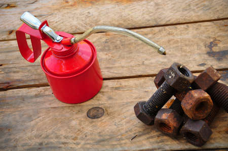Oil can on wooden background, Lube oil can and used in industry or hard works.の写真素材