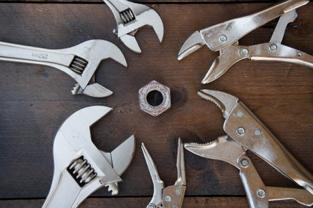 Adjustable wrench or spanner wrench and Locking pliers on wooden background, Prepare basic hand tools for work.の写真素材
