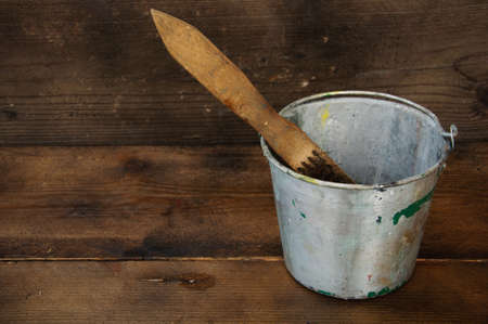 Paint cans or paint bucket on wooden background.の写真素材