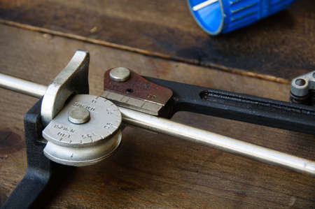 Tube bender or pipe bender tools on wooden background.の写真素材