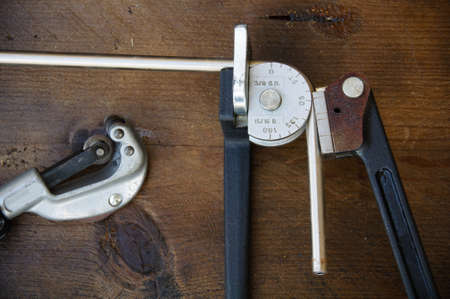 Tube bender or pipe bender tools on wooden background.の写真素材