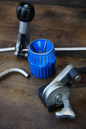 Tube bender or pipe bender tools on wooden background.の写真素材