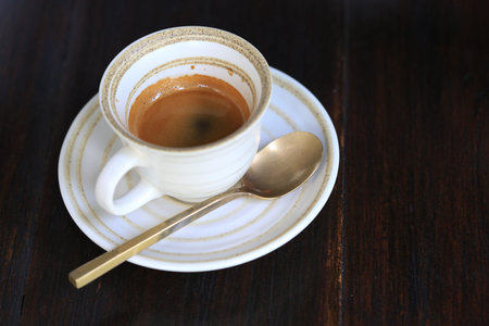 Fresh coffee on wooden table. Espresso coffee short on table.