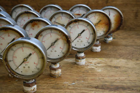 Old pressure gauge or damage pressure gauge of oil and gas industry on wooden background, Equipment of production process.の写真素材