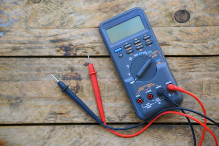 Close-up of digital multimeter on wooden background, Worker used electronic tools for checked circuit, Special tools on electronic job.の写真素材