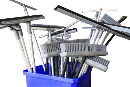 Collection of cleaning products and tools on white background Broom for cleaning and Floor squeegee...