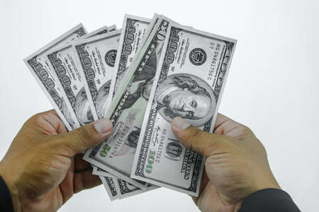 Trap with dollar bills isolated over white background, Risk in business, Businessman taking money from a mousetrap.の写真素材