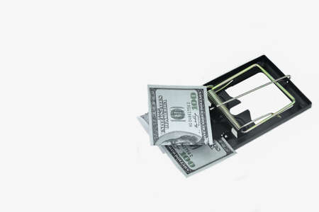 Trap with dollar bills isolated over white background, Risk in business, Businessman taking money from a mousetrap.の写真素材