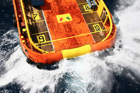 Supply boat transfer cargo to oil and gas industry and moving cargo from the boat to the platformの写真素材