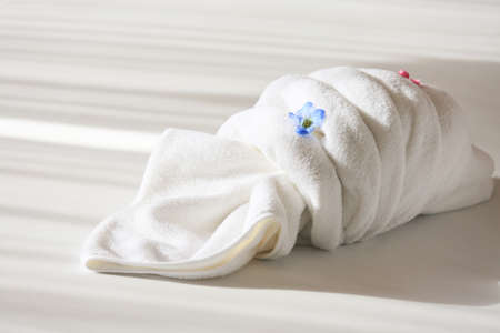 Creative towel on the bed in the hotel, towel set prepare for use in private room, equipment in rent room or hotel.の写真素材