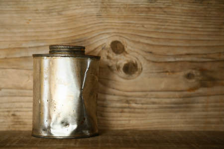 paint bucket or paint can on wooden background, artist using paint bucket for mixing color for pictures.の写真素材