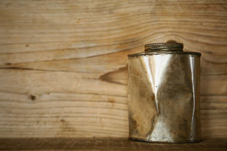 paint bucket or paint can on wooden background, artist using paint bucket for mixing color for pictures.の写真素材