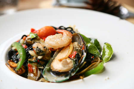 Spaghetti with prawns and seafood on white plateの写真素材