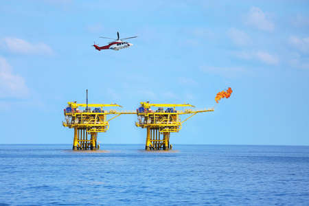 Offshore construction platform for production oil and gas, Oil and gas industry and hard work,Production platform and operation process by manual and auto function, oil and rig industry and operation.の写真素材