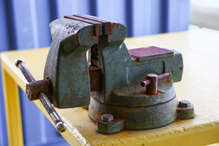 Vise tool in workshop or the garage for support hard work, Special tools for industry job, vise stand on the table with other basic tool, Hand tool on table for service and repair in industry job.の写真素材