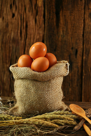 Fresh eggs on wooden background from farm and prepare for cook in kitchen room. Organic food and...