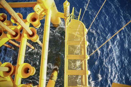 Offshore construction platform for production oil and gas, Oil and gas industry and hard work, Production platform and operation process by manual and auto function, oil and rig industry and operation.の写真素材