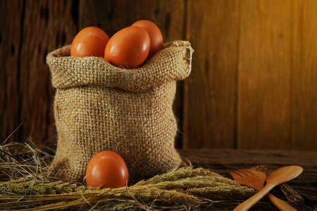 Fresh eggs on wooden background from farm and prepare for cook in kitchen room, Organic food and clean food for healthy, Eggs from farm to the market for raw material to cooking by chef in restaurant.の写真素材