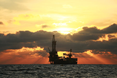 Oil and rig in offshore with sunset and sunrise time. The construction platform for production oil and gas in power and energy industry.の写真素材