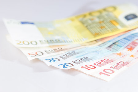 Euro notes lying on other notes with light white background