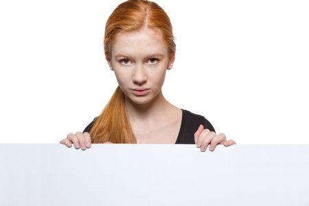 Cute teen girl holding a white sign