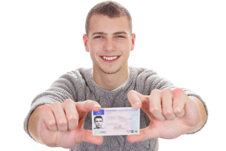 16 to 18 year old boy just received his driver licenseの写真素材