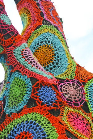 Abstract colorful crochet web over tree