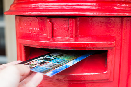 Traditional Red Postbox with postcard dropping