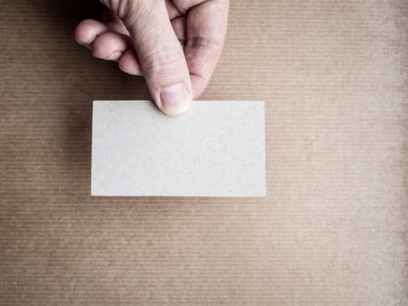 Mock up of business card in man's handの写真素材