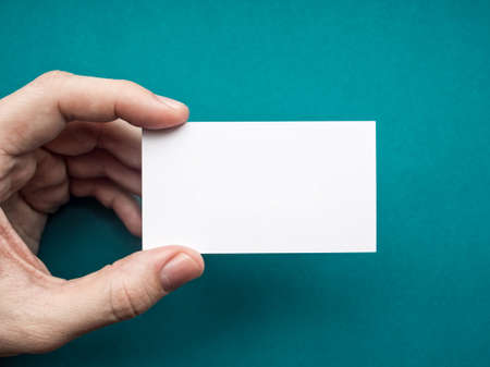 White business card Mock up in men's handの写真素材