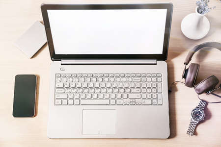 Workspace with laptop mockup, blank white screenの写真素材