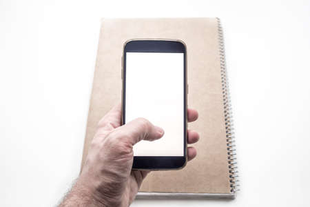 Hand holding and using mobile smartphone mockupの写真素材