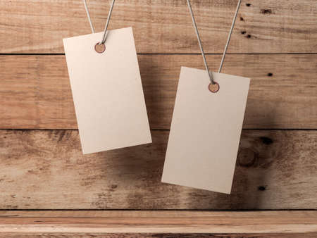 Two Empty kraft paper tags label Mockup tied by rope on wooden boxの写真素材