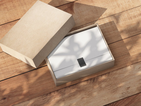 Opened carton Gift Box Mockup with white wrapping paper on the wooden table outdoorの写真素材