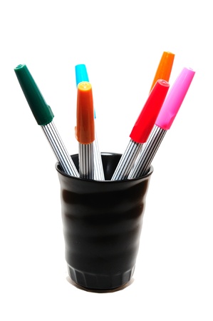 colorful pens in black grassの写真素材