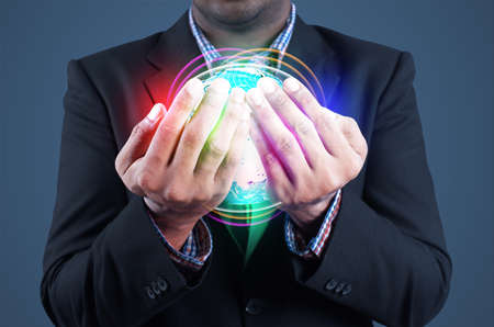 Businessman holds globe in a handsの写真素材