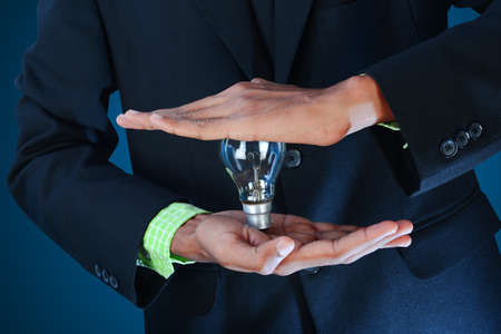 Business idea  Businessman holding light bulb の写真素材