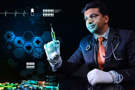 Young doctor with a syringe and pillsの写真素材