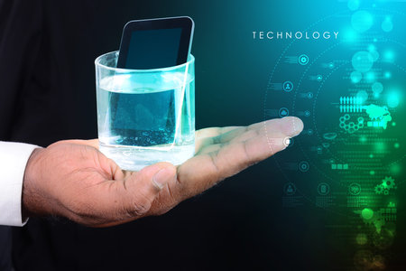 man hand showing a glass of water and tablet phone