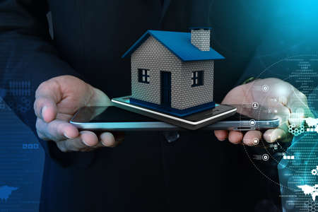 Showing home with smart phoneの写真素材