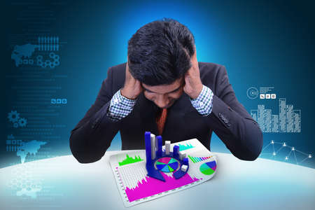 Business man studying the financial graph and pie chartの写真素材