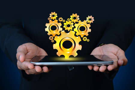 businessman showing gears cogs to success conceptの写真素材