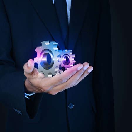 businessman showing gears cogs to success conceptの写真素材