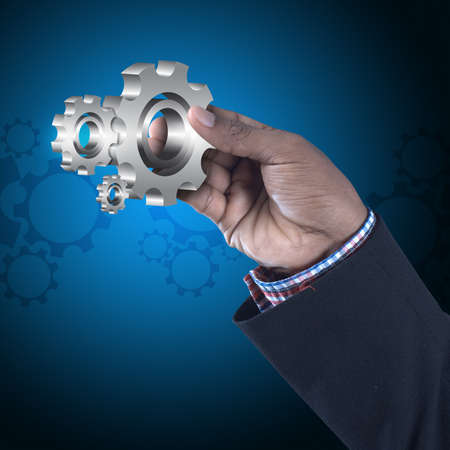 businessman showing gears cogs to success conceptの写真素材