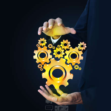 businessman showing gears cogs to success conceptの写真素材