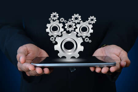 businessman showing gears cogs to success conceptの写真素材