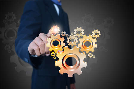 businessman showing gears cogs to success conceptの写真素材